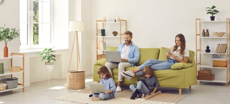 Family relaxing in their living room while using fast home internet