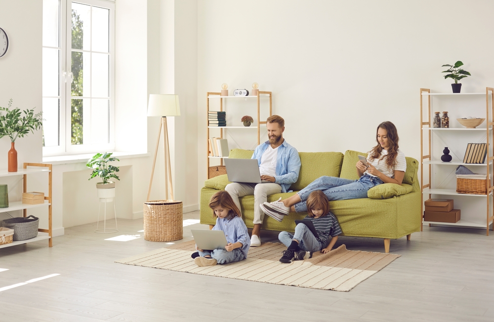 Family relaxing in their living room while using fast home internet